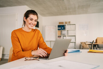 Young businesswoman smiling with delight and satisfaction