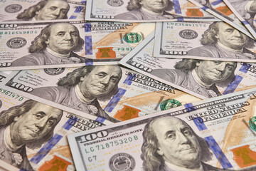 Background with one hundred dollar bills. Foreshortening from above at an acute angle.