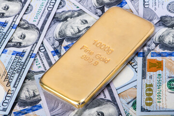 Gold bar on american dollar banknotes.