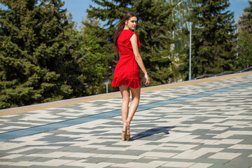 Portrait of a young beautiful woman in red dress