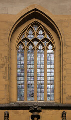 Obraz premium Pointed gothic window arch with tracery at St John church in the old town of Kitzingen, Franken region in Germany