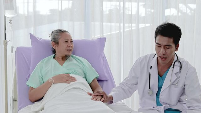 Asian man professional doctor talker asked about the patient's condition on the bed, Ask about Tech sick Caring for a patient in a hospital bed