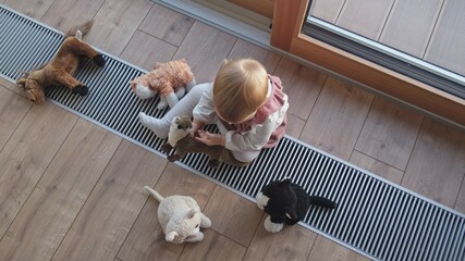 Fototapeta na wymiar Happy Adorable Caucasian Toddler Baby Girl Playing with Fluffy Cat and Horse Cuddly Toys