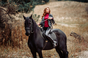 Obraz premium Beautiful young woman posing with a horse outdoors, close up