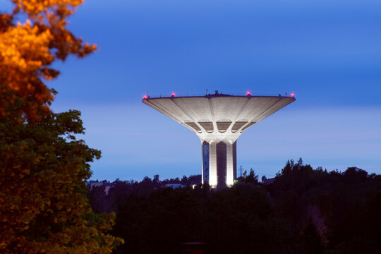 Helsinki / Finland - JUNE 3, 2019: Illuminated municipal water tower of Roihuvuori, owned and operated by Helsinki Region Environmental Services HSY, was built in 1977.