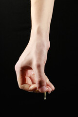 liquid flows from the hand on a black background