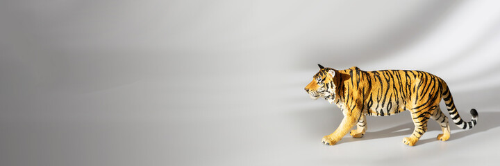 Tiger symbol of the Chinese new year 2022. Figurine of tiger isolated on white background with shadows. Copy space.