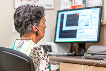 Senior woman having an audiometry test © TOimages