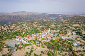 Obraz premium Aerial view of famous landmark tourist destination valley Pano Lefkara village, Larnaca, Cyprus. Ceramic tiled house roofs, greek orthodox church at south of Troodos hills, Kionia, from above