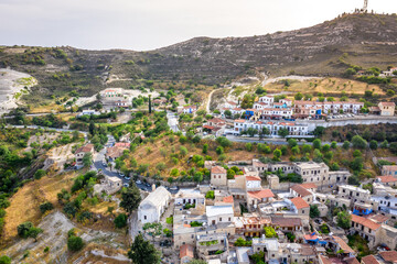 Fototapeta na wymiar Aerial view of famous landmark tourist destination valley Pano Lefkara village, Larnaca, Cyprus. Ceramic tiled house roofs, greek orthodox church at south of Troodos hills, Kionia, from above