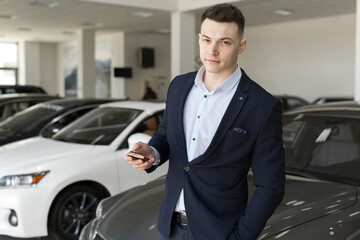 Fototapeta na wymiar Handsome man choosing a car in a show room
