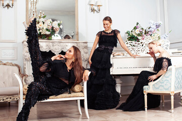 three young pretty lady in black lace fashion style dress posing in rich interior of royal hotel room, luxury lifestyle people concept