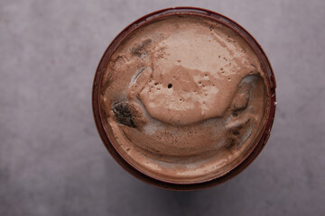 close up of chocolate flavor ice cream in a container 