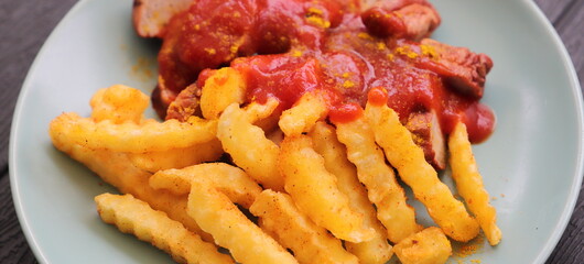 delicious sausage with french fries and curry sauce