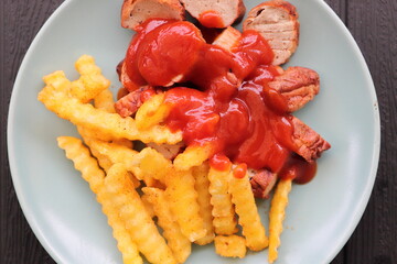 delicious sausage with french fries and curry sauce