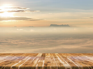 Fototapeta na wymiar Sunrise in mountain mist with Empty wooden table