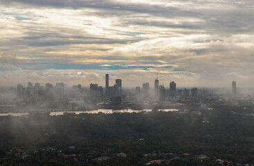 Bangkok, thailand -Sep 16, 2021 : An impressive aerial top view of skyscrapers at downtown Bangkok city along the chao phraya river in morning fog. No focus, specifically.