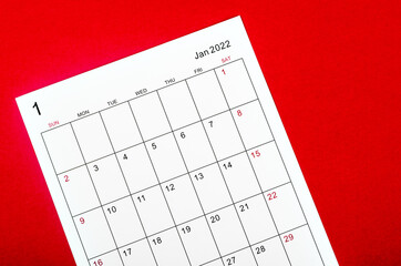 January 2022 calendar sheet on red background.