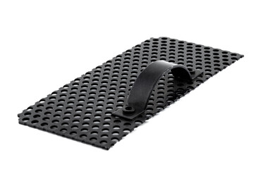 Macro shot of a black metal surface with round holes and handle, isolated on a white background.