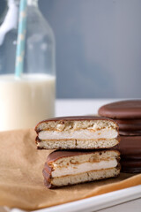 Tasty choco pies on parchment paper. Snack cakes