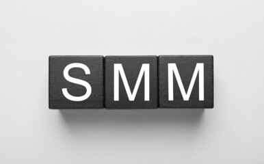 Cubes with abbreviation SMM (Social media marketing) on white background, top view