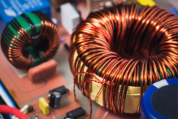 Close-up of copper coil on the power supply circuit board, transformers amplifier, electronic...
