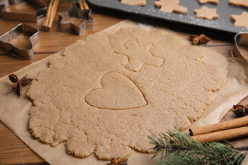 Homemade Christmas cookies. Raw dough on wooden table, closeup