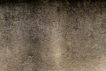 Old cement wall has black color water stains, dark tone.
