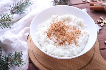 Christmas rice pudding with cinnamon on a wooden background