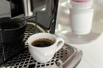 Coffee maker pouring fresh espresso coffee