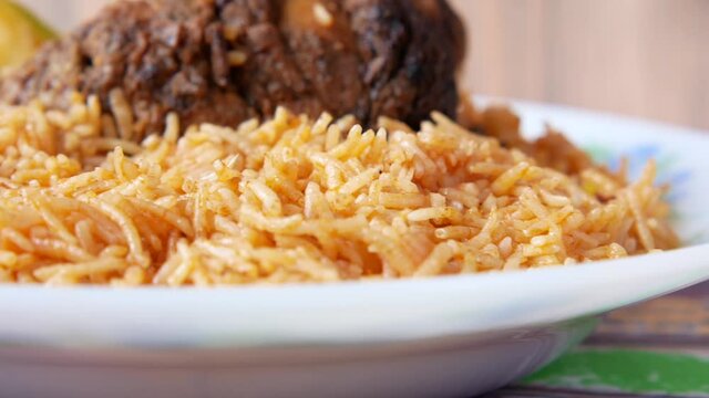 close up of mutton biryani meal in a plate on table.