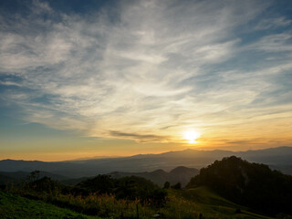 Naklejka na ściany i meble sunrise on mountain range and blue sky with white clouds