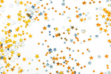 Gold and silver stars, holiday confetti on a white background