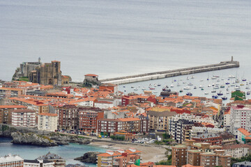 Obraz premium Port of Castro Urdiales, with the Church and the beach of Ostende.