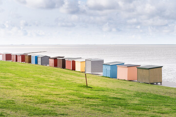 Colorful beach houses and bathhouses on the dike of Dagebüll