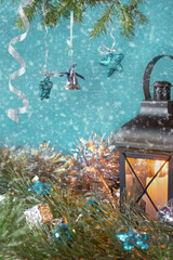 New Year card with a flashlight, fir branches and a garland.