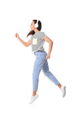 Jumping young African-American woman with headphones on white background