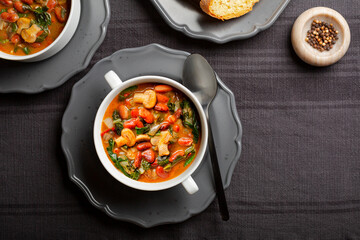Italian vegetable soup with bean, mix of mushrooms, tomatoes and chard. Zimino di fagioli. Toasted...