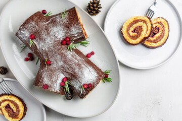Yule log or Buche de Noel. Traditional Christmas cake. Sponge cake with chocolate cream, ganache,...