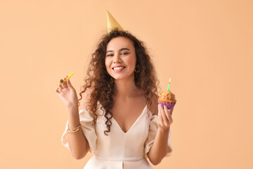 Happy African-American woman with Birthday cake on color background