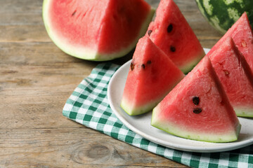 Delicious fresh watermelon slices on wooden table, closeup. Space for text