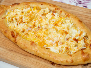close-up of a small khachapuri in Ajarian. Home cooking, Georgian dishes Top vie, flat lay