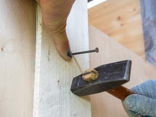 A close-up of an employee missed with a hammer and hit his finger. Bruise, hematoma, injury....