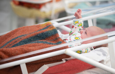 A newborn in the childbearing center lie in the boxes.