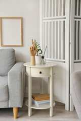 Wooden hand and reed diffuser on white table
