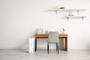 Stylish workplace near wall in room