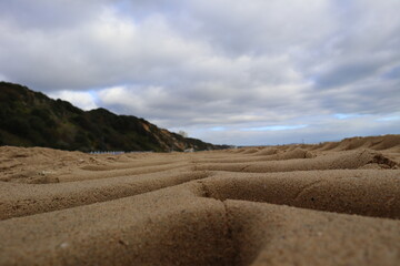 tractor tracks in the yellow beach sand
