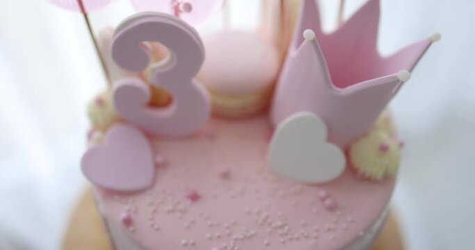 decorated birthday cake with hearts, crown and sugar beads for three years old baby girl