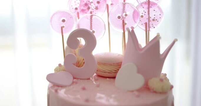 decorated birthday cake with hearts, crown and sugar beads for three years old baby girl