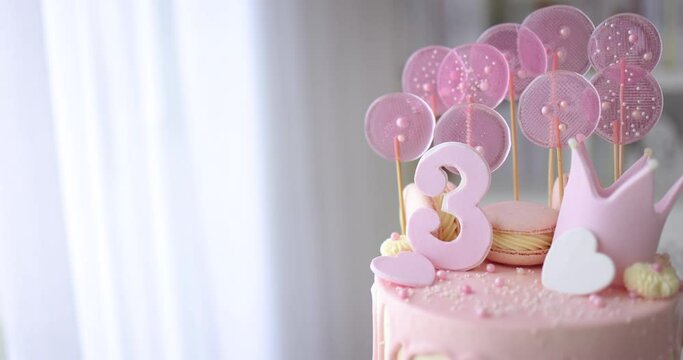 decorated birthday cake with hearts, crown and sugar beads for three years old baby girl